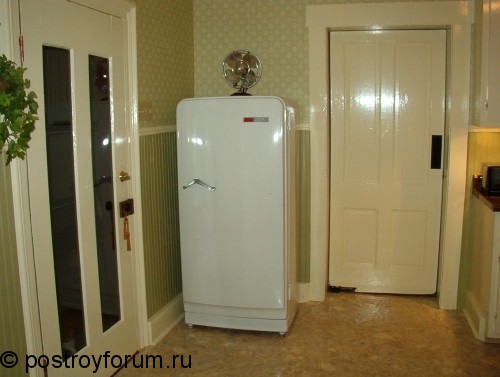 Холодильник в зеленой кухне